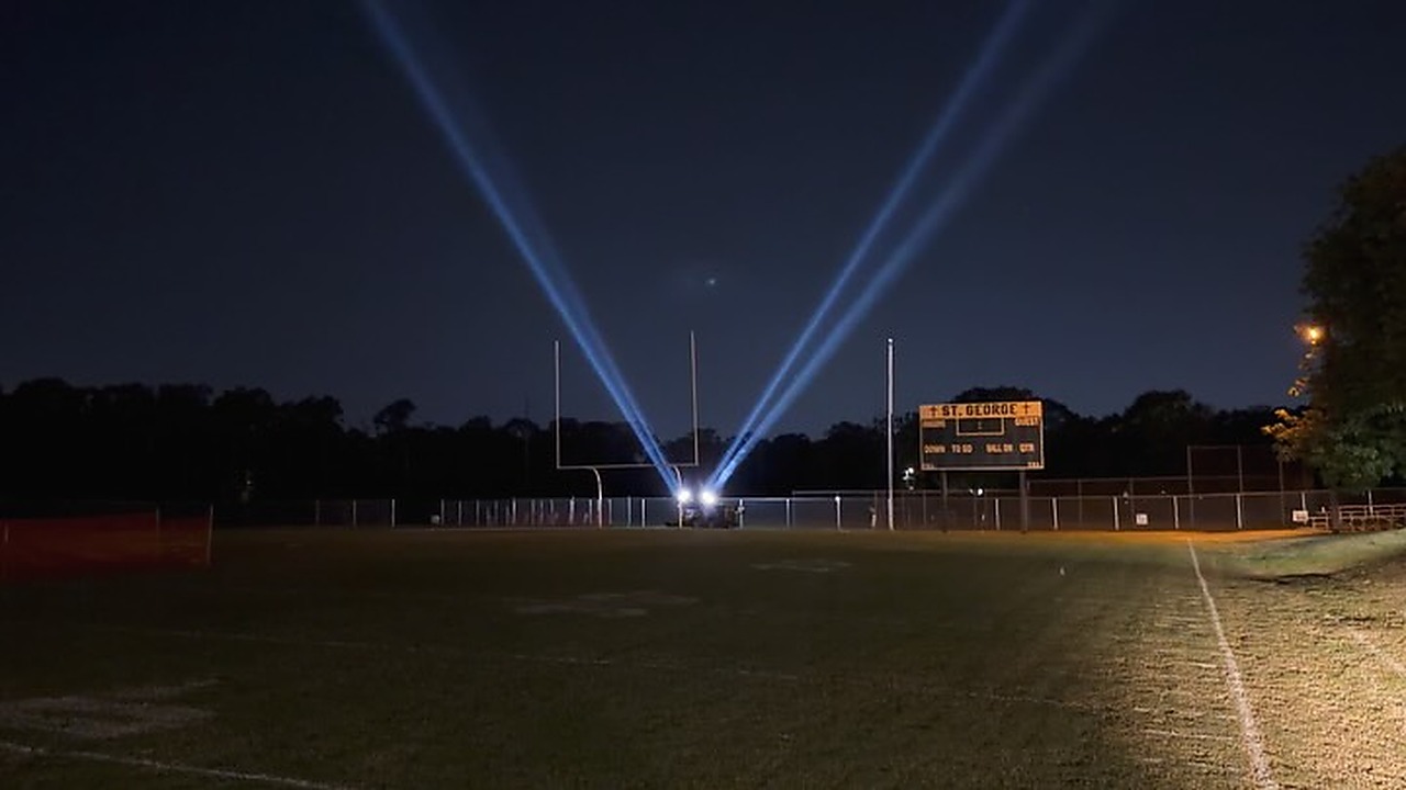 Four 5,600K xenon searchlight beams sweeping the night sky at the St. George Fair in Baton Rouge