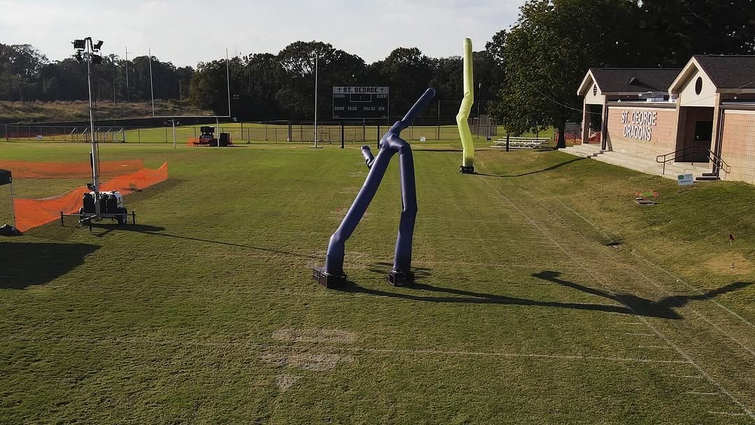 Blue and yellow Fly Guys and mobile light tower deployed on St. George athletic field