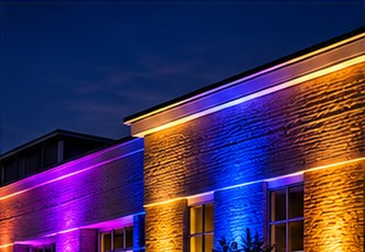 Mansion columns illuminated in purple and gold architectural LED uplighting